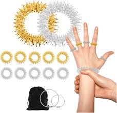 The image features five gold and five silver sensory finger rings, along with a gold and silver bracelet sensory ring on a white background. Besides it, there are two hands. The left hand wears alternating gold and silver rings, while the right hand fiddles with the silver sensory bracelet.