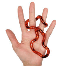 An open hand is shown with an orange tangle toy tangled around two of its fingers, against a white background, ideal for sensory stimulation or stress relief.